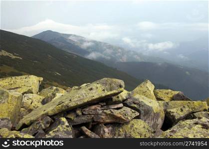 lichen-grown stones and clouds in Gorgany region of Carpathian mountains (Ukraine)