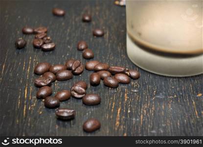 Lie Emptied of a cup of coffee and coffee beans