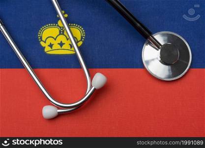 Liechtenstein flag and stethoscope. The concept of medicine. Stethoscope on the flag as a background.. Liechtenstein flag and stethoscope. The concept of medicine.