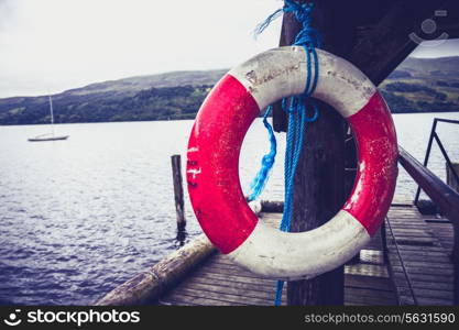 Life belt hanging on a pier by a lake