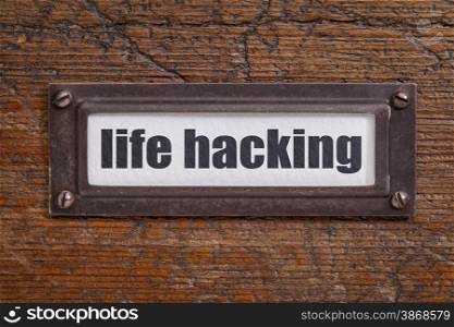 life hacking tag - file cabinet label, bronze holder against grunge and scratched wood
