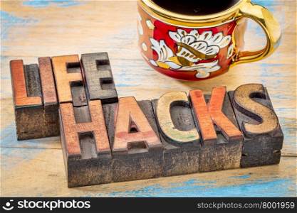 life hacks - word abstract in vintage letterpress printing blocks stained by color inks with a cup of coffee