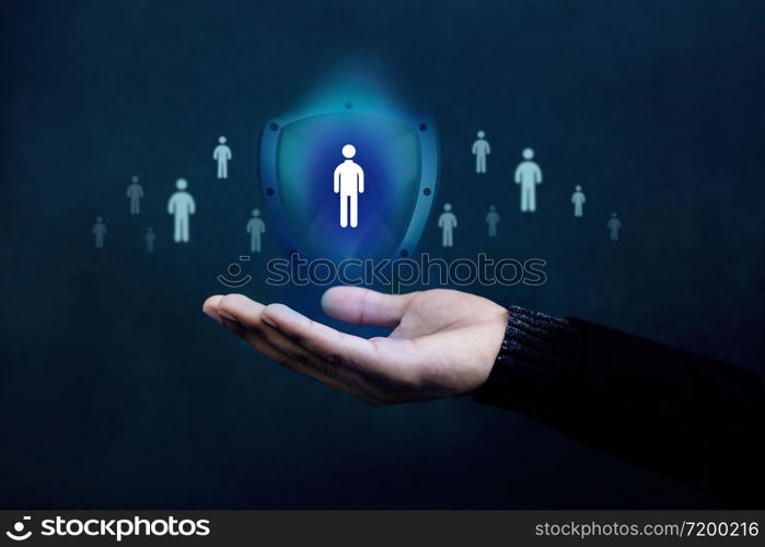 Life Insurance Concept. Company Supporting and Protecting their Customer by Shield, Human Icon floating over a Careful Gesture Hand of a Businessman
