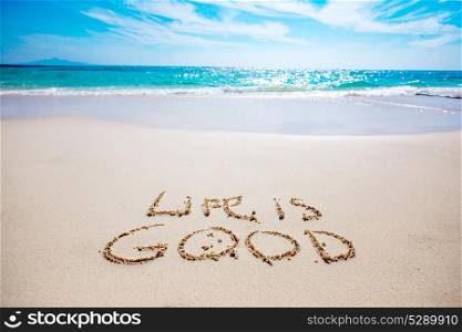 Life is good text on sandy beach. Life is good text on white sandy beach and sea