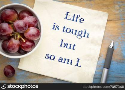 Life is tough, so am I.. Life is tough, so am I - positive affirmation. Hnadwriting on a napkin with grapes.