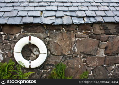 Life-preserver on a wall in a fishermen village - Scotland