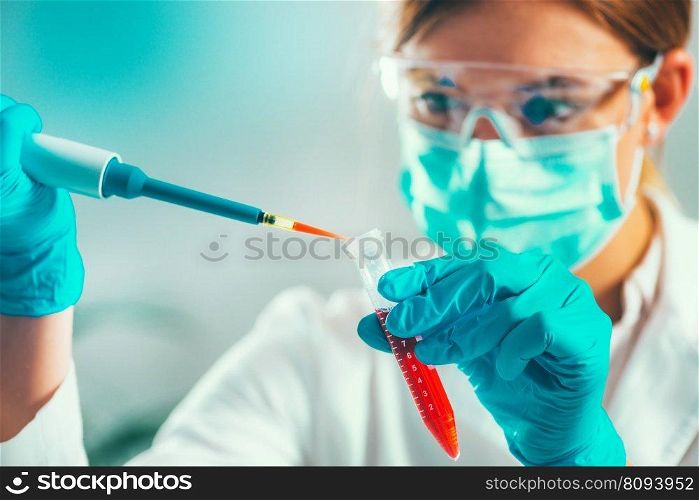Life science research. Technician using micro pipette