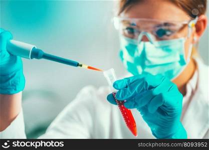 Life science research. Technician using micro pipette