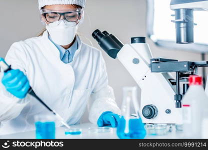 Life science research. Technician using micro pipette