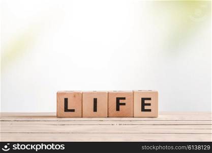 Life sign made of wooden blocks on a desk