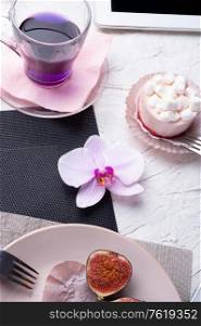 life style concept. Thai blue, Butterfly pea tea served with fresh figs and panna cotta cake and fruit piece of cake on serving napkins.