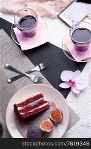 life style set at meeting in cafe.Thai blue, Butterfly pea tea served with fresh figs and panna cotta cake and fruit piece of cake on serving napkins.