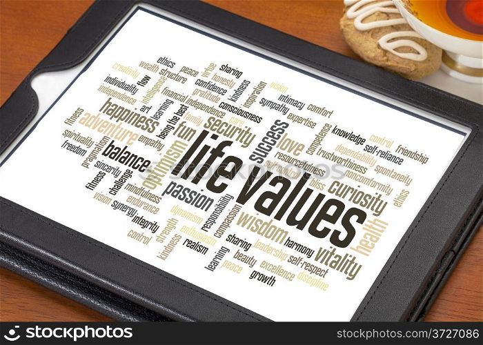 life values - word cloud on a digital tablet with a cup of tea