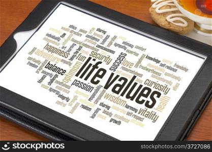 life values - word cloud on a digital tablet with a cup of tea