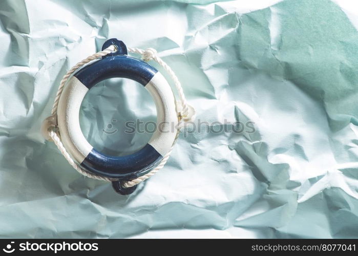 Lifebelt on blue paper background