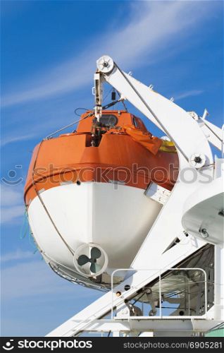 Lifeboat on a big ship on a background of blue sky