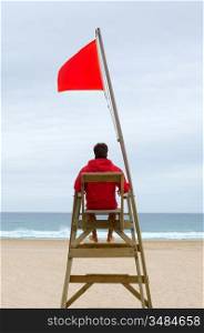 Lifeguard sitting in his chair watching the sea