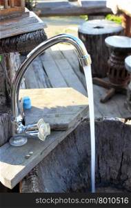 Lifestyle-a faucet with water flowing