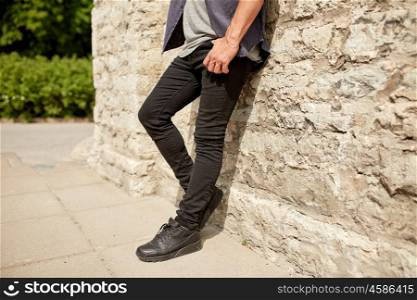 lifestyle and people concept - close up of man standing at street wall. close up of man standing at street wall