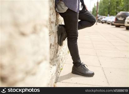 lifestyle and people concept - close up of man standing at street wall. close up of man standing at street wall