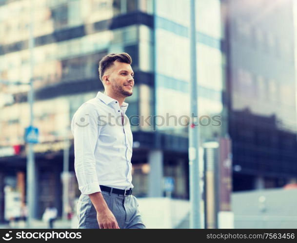 lifestyle and people concept - young man walking along city street. young man walking along city street