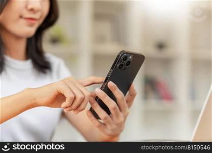 Lifestyle and technology concept, Young Asian woman using smartphone to working online at home
