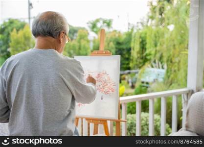 Lifestyle artist. Senior old man painting picture artwork using brush and water color on canvas, portrait elderly white haired paint at his easel outside green nature, Happy retirement and activity