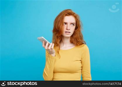 Lifestyle concept - Portrait of a shocked surprised girl in yellow dress talking on mobile phone. Isolated on Blue Pastel Background. Copy space.. Lifestyle and Technology concept - Portrait of cheerful happy ginger red hair girl with joyful and exciting smiling to camera. Isolated on Blue Pastel Background. Copy space.