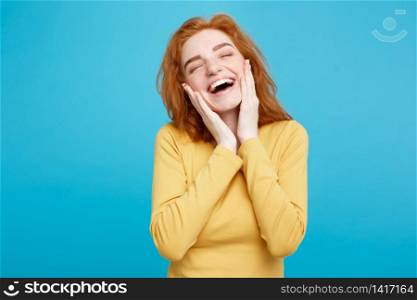 Lifestyle concept - Portrait of cheerful happy ginger red hair girl with joyful and exciting smiling to camera. Isolated on Blue Pastel Background. Copy space.