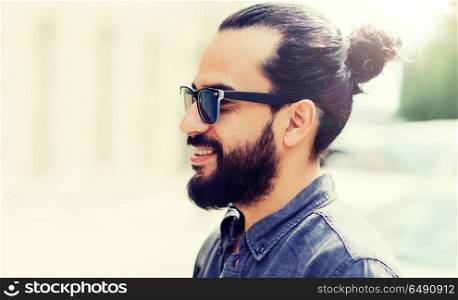 lifestyle, emotion, expression and people concept - happy smiling man with beard and sunglasses on city street. happy smiling man with beard on city street. happy smiling man with beard on city street
