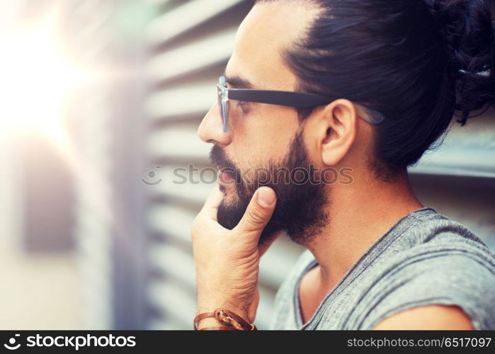 lifestyle, emotion, expression and people concept - happy smiling man with sunglasses and beard on city street. happy smiling man with beard on city street. happy smiling man with beard on city street