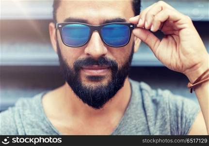 lifestyle, emotion, expression and people concept - happy smiling man with sunglasses and beard on city street. happy smiling man with beard on city street. happy smiling man with beard on city street