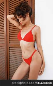 Lifestyle fashion photo of beautiful graceful woman in red bikini. Spring Summer. Beach summer vibes. Travel season