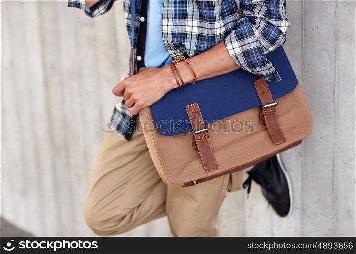 lifestyle, fashion, style and people concept - close up of hipster man with stylish shoulder bag