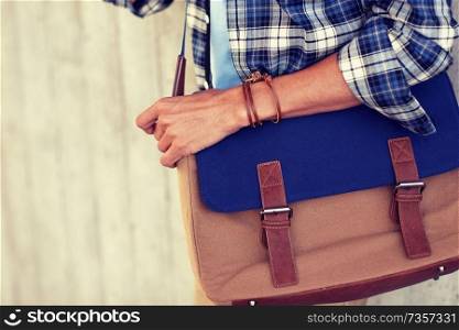 lifestyle, fashion, style and people concept - close up of hipster man with stylish shoulder bag. close up of hipster man with stylish shoulder bag