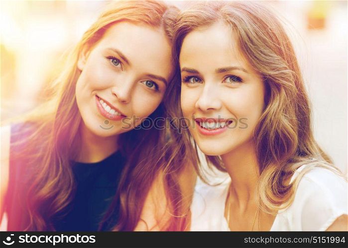 lifestyle, friendship and people concept - happy young women or teenage girls outdoors. happy young women or teenage girls
