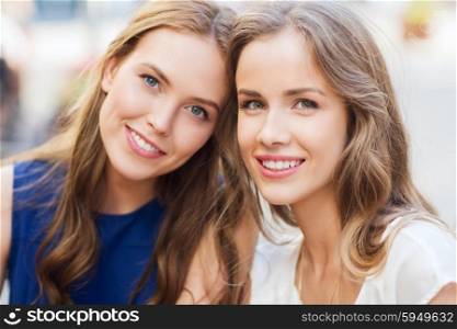 lifestyle, friendship and people concept - happy young women or teenage girls outdoors
