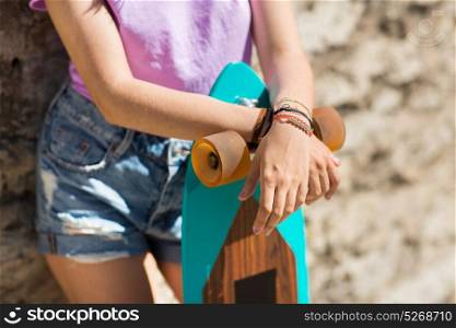 lifestyle, leisure and people concept - close up of teenage girl or young woman with longboard. close up of teenage girl with longboard
