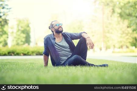 lifestyle, leisure and people concept - man in sunglasses at city street or park. man in sunglasses at city street or park. man in sunglasses at city street or park