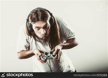Lifestyle of young people. Student man spending time on playing games videogames console playstation. Long haired guy focus on gaming.. Male player focus on play games