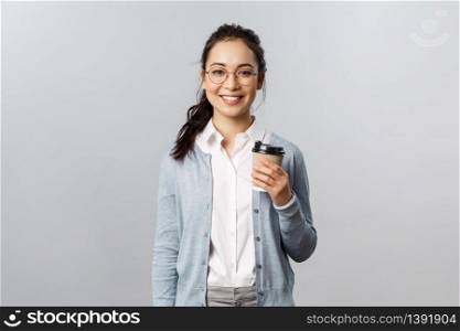 Lifestyle, people and emotions concept. Attractive young woman, female employee buying take-away coffee on her way to work office, smiling cheerful, casual ordinary day with coworkers doing their job.. Lifestyle, people and emotions concept. Attractive young woman, female employee buying take-away coffee on her way to work office, smiling cheerful, casual ordinary day with coworkers doing their job