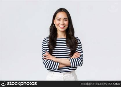 Lifestyle, people emotions and casual concept. Confident nice smiling asian woman cross arms chest confident, ready to help, listening to coworkers, taking part conversation.. Lifestyle, people emotions and casual concept. Confident nice smiling asian woman cross arms chest confident, ready to help, listening to coworkers, taking part conversation