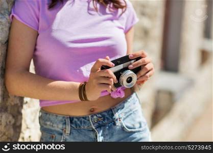 lifestyle, photography and people concept - close up of teenage girl or young woman with vintage camera outdoors. close up of woman with vintage camera outdoors