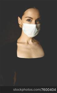 Lifestyle portrait of young beautiful lady with medical mask. Stay home. Coronavirus. Quarantine. Coronavirus pandemic in the world