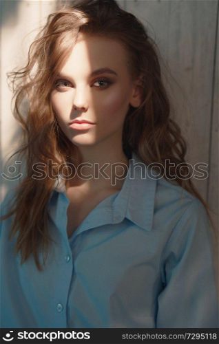 Lifestyle portrait of young woman with curly hair. Natural beauty. Summer light.