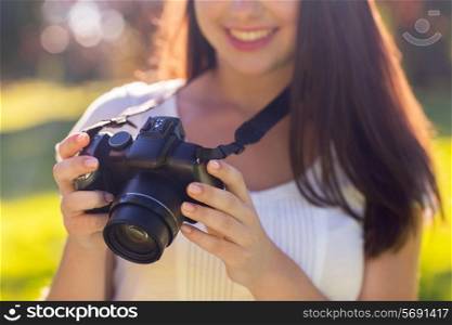 lifestyle, summer, vacation, technology and people concept - close up of young girl with photo camera outdoors