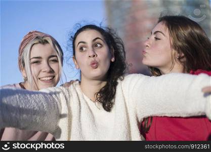 Lifestyle sunny image of best friend girls taking selfie on camera, crazy emotions , happy vacations, shopping day.