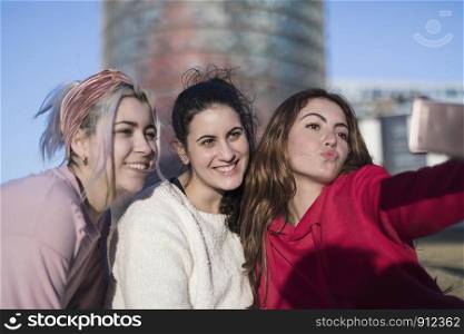 Lifestyle sunny image of best friend girls taking selfie on camera, crazy emotions , happy vacations, shopping day.