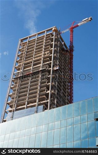 Lifting crane and high building under construction