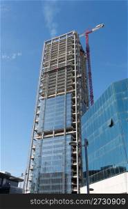 Lifting crane at skyscraper construction site